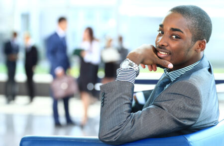 portrait,of,smiling,african,american,business,man,with,executives,working