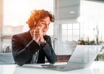 portrait,of,smiling,and,positive,handsome,businessman,in,suit,sitting